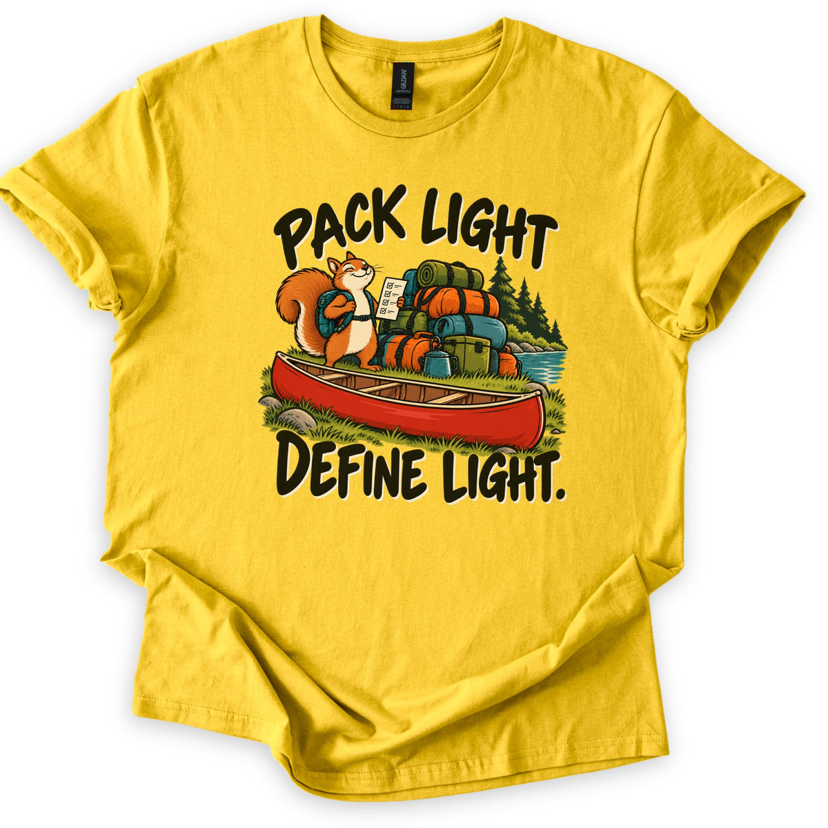 Pack Light Define Light Comfort Colors T-shirt in Daisy, laid flat. A smiling cartoon squirrel with a backpack holds a checklist beside a red canoe and a tall pile of camping gear by a lake, between the words Pack Light and Define Light. The shirt lies on a white background.