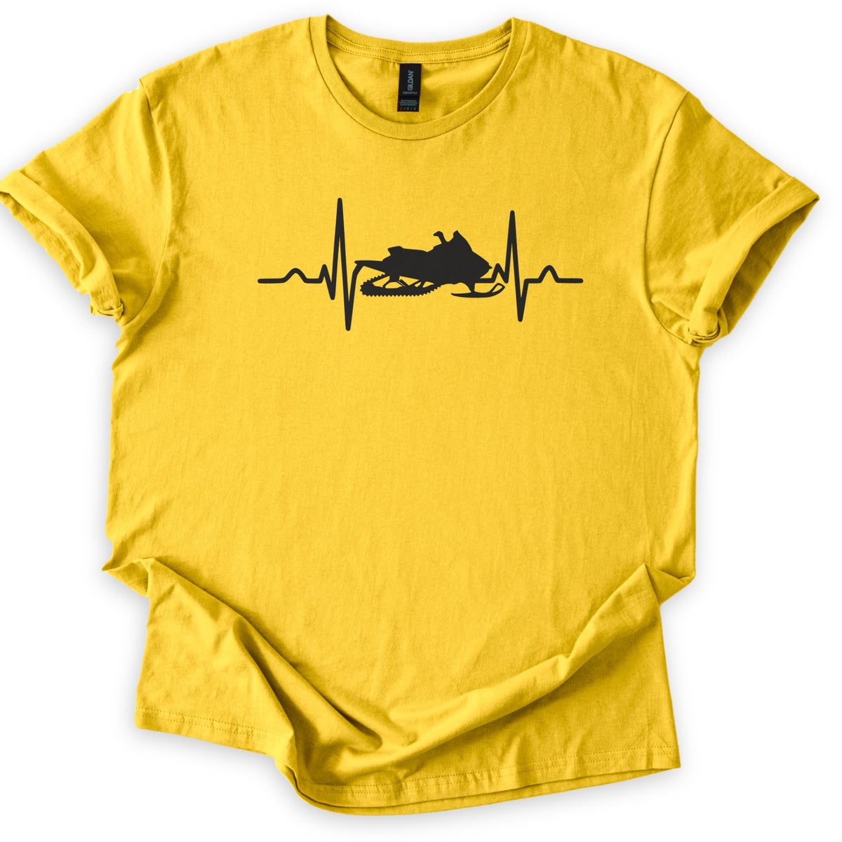 Heartbeat Snowmobile Comfort Colors T-shirt in Daisy, laid flat. A black heartbeat line runs across the chest with a snowmobile silhouette set into the middle of the pulse, with no words. The shirt has rolled sleeves and lies on a white background.