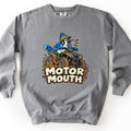 Motor Mouth Comfort Colors crewneck sweatshirt in Grey, laid flat. A cartoon blue jay in a tan helmet squawks while riding a green ATV through splattering mud above the words Motor Mouth in cream block letters. Shown on a white background.