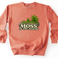 Moss in the Making Comfort Colors crewneck sweatshirt in Terracotta, laid flat. A rock covered in bright green moss with leafy plants sprouting on top sits above cream lettering that reads Moss in the Making. The sweatshirt lies on a white background.