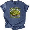 Small World Full Time Hobby Comfort Colors T-shirt in Heather Navy, laid flat. A glass terrarium jar of green moss and gray rocks on gravel, with metal tweezers beside it, between the words Small World and Full Time Hobby. in green and gold letters. Sleeves cuffed, on a white background.