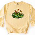 Stained Glass Moss Comfort Colors crewneck sweatshirt in Butter, laid flat. A stained glass style clump of green moss with three amber spore capsules on tall orange stalks, outlined in dark leading, with no words. The sweatshirt lies on a white background with its sleeves out.