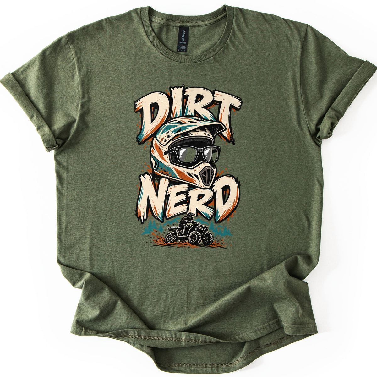 Dirt Nerd Comfort Colors T-shirt in Military Green, laid flat. The words Dirt Nerd in cream brushstroke letters frame a motocross helmet wearing black glasses, above a rider on an ATV kicking up orange dirt. The sleeves are cuffed, on a white background.