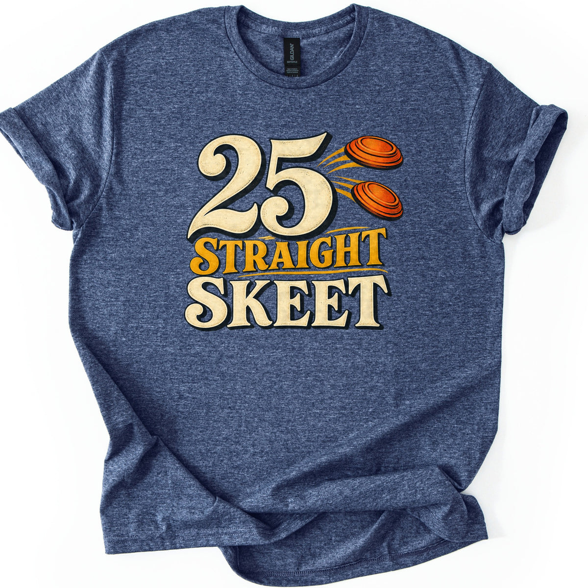 25 Straight Skeet Comfort Colors T-shirt in Heather Navy, laid flat. Large cream numbers 25 with two orange clay targets flying beside them, above the words Straight Skeet in gold and cream lettering. The shirt has rolled sleeves on a white background.