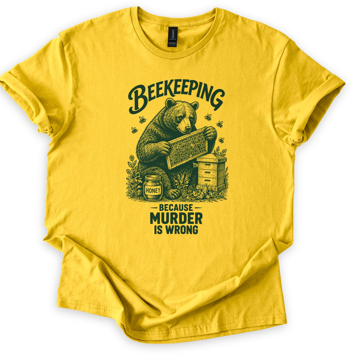 Beekeeping Murder Bear Comfort Colors T-shirt in Daisy, laid flat. A dark green etched drawing of a bear holding a honeycomb frame by a beehive and a jar labeled Honey, with bees flying, under the word Beekeeping and above Because Murder Is Wrong. Shown on white with cuffed sleeves.