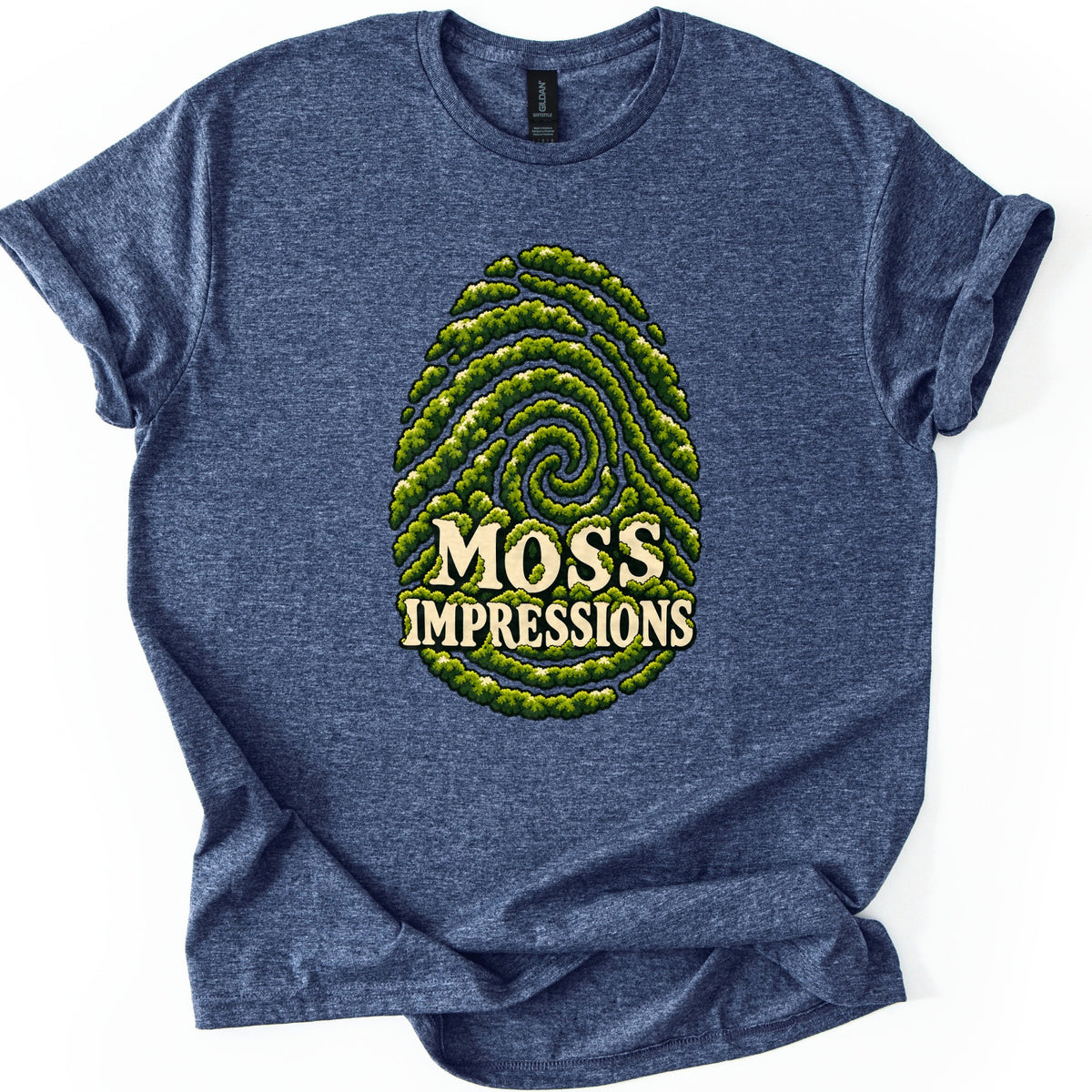 Moss Impressions Comfort Colors T-shirt in Heather Navy, laid flat. A large fingerprint made of swirling ridges of green moss, with the words Moss Impressions in cream lettering across its lower half. The shirt has rolled sleeves and lies on a white background.
