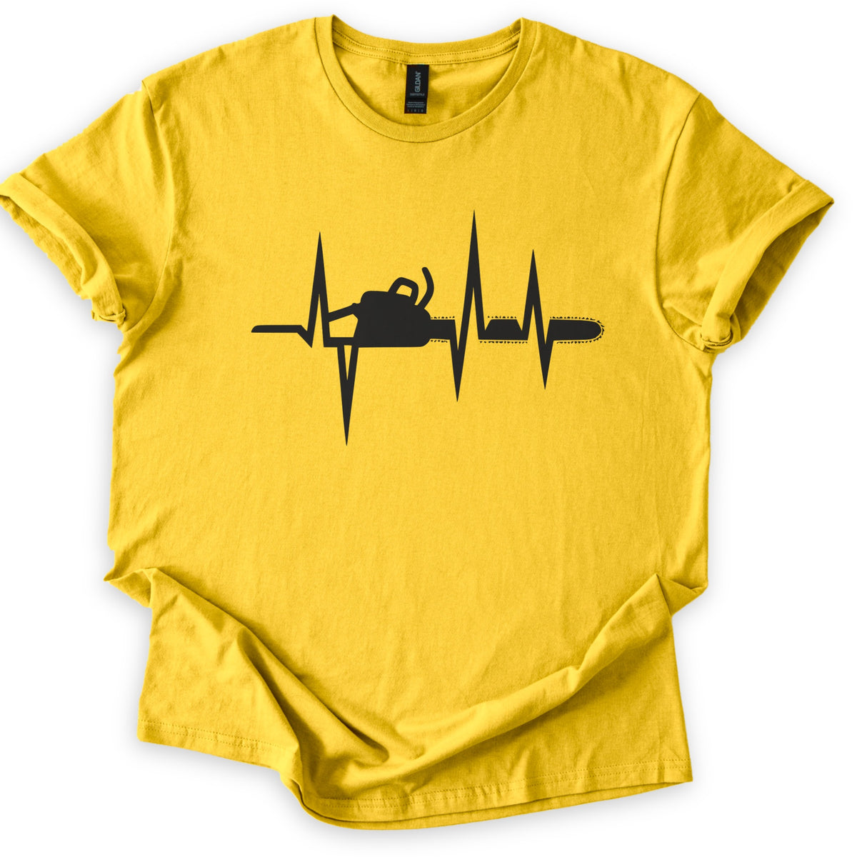 Chainsaw Heartbeat Comfort Colors T-shirt in Daisy, laid flat. A black heartbeat line with sharp peaks runs across the chest, with a chainsaw silhouette set into the line, its bar and chain extending to the right. The sleeves are rolled on a white background.