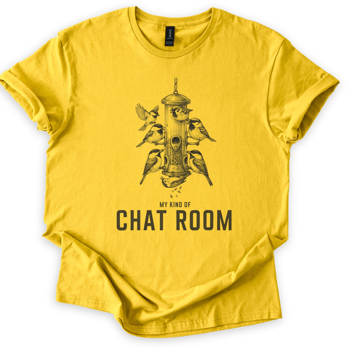 My Kind Of Chat Room Comfort Colors T-shirt in Daisy, laid flat. A sketch of chickadees and sparrows perched around a hanging tube bird feeder, one upside down below spilling seeds, above the words My Kind Of Chat Room in dark gray. Sleeves rolled, on a white background.