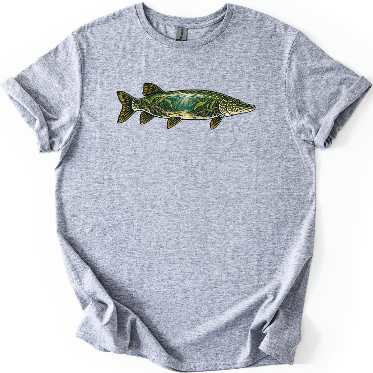 Pike Weed Bed Comfort Colors T-shirt in Sport Grey, laid flat. A northern pike faces right across the chest, its body filled with an underwater scene of green weeds and sun rays over a sandy bottom, with gold fins. No words. Sleeves are cuffed on a white background.