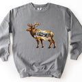 Aspen Pass Elk Comfort Colors crewneck sweatshirt in Grey, laid flat. A painted bull elk with large antlers stands facing left, its body filled with a scene of white aspen trees, golden leaves, snowy ground and a mountain. No words are printed. Shown on a white surface.