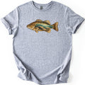 Rocky Shallows Bass Comfort Colors T-shirt in Sport Grey, laid flat. A gold and brown bass is printed across the chest, its body filled with an underwater scene of teal water, light rays and rounded rocks. No words are printed. The shirt has rolled sleeves on a white background.