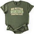 No Putter Required Comfort Colors T-shirt in Military Green, laid flat. Wavy retro letters read NO PUTTER in cream, REQUIRED in larger sage green, and SPORTING CLAYS in cream below. The shirt lies on a white background with its sleeves rolled.