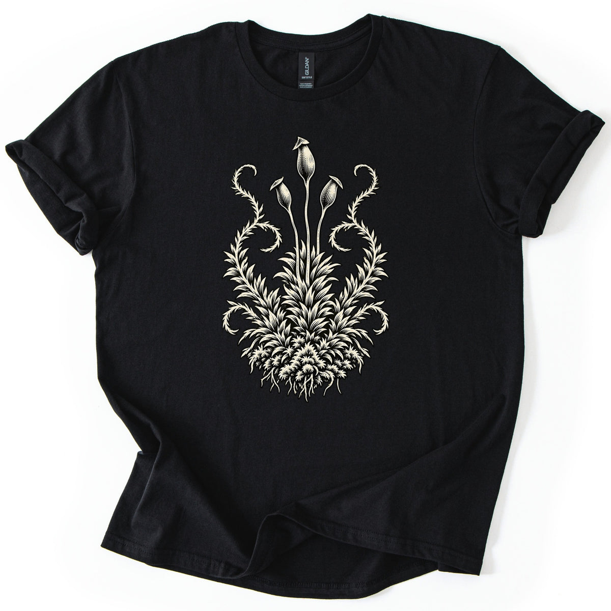 Moss Woodcut Comfort Colors T-shirt in Black, laid flat. A cream woodcut-style illustration of a moss clump with roots, spiky leaves, curling side fronds and three tall stalks topped with spore capsules. The sleeves are rolled, on a white background.