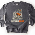 Everyone Relax, I'm Wearing Orange Comfort Colors crewneck sweatshirt in Pepper, laid flat. A sketched whitetail buck in an orange hunting vest and orange cap stands in a pine forest above the words Everyone Relax, I'm Wearing Orange, with Orange in orange. Shown on a white background.