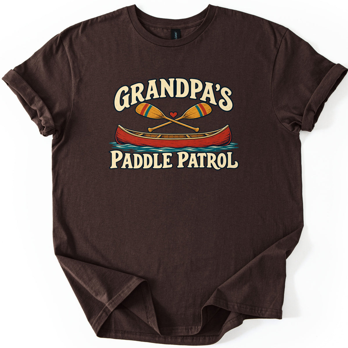 Grandpas Paddle Patrol Comfort Colors T-shirt in Dark Chocolate, laid flat. Cream lettering reads Grandpa's above two crossed wooden paddles with a small red heart and a red canoe on blue water, with Paddle Patrol below. The shirt lies on a white background with sleeves rolled.