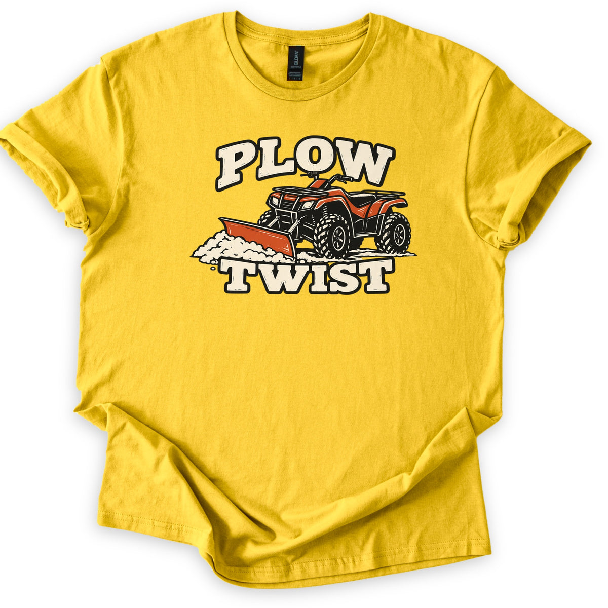 Plow Twist Comfort Colors T-shirt in Daisy, laid flat. An orange ATV with a front plow blade pushes a pile of snow, with the words Plow Twist in cream block letters above and below. The shirt lies on a white background with the sleeves cuffed.