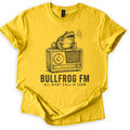 Bullfrog FM Comfort Colors T-shirt in Daisy, laid flat. A black ink sketch of a croaking bullfrog on a vintage radio, sound waves at its mouth, above the words BULLFROG FM and ALL NIGHT CALL-IN SHOW. Sleeves are cuffed on a white background.