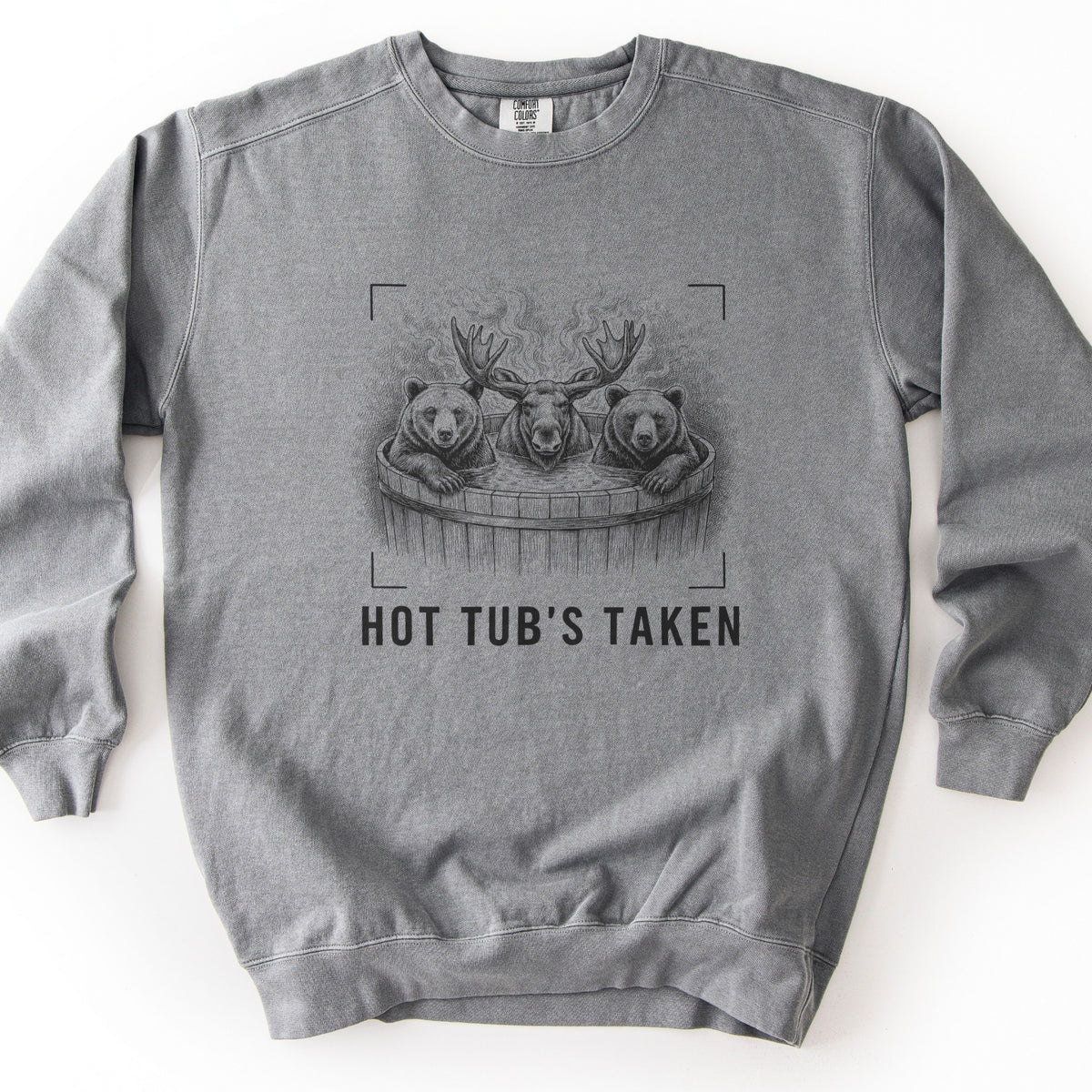 Hot Tub's Taken Comfort Colors crewneck sweatshirt in Grey, laid flat. A black sketch of two bears and a moose soaking in a steaming wooden barrel hot tub, framed by camera viewfinder corners, above the words HOT TUB'S TAKEN. Shown on a white background.
