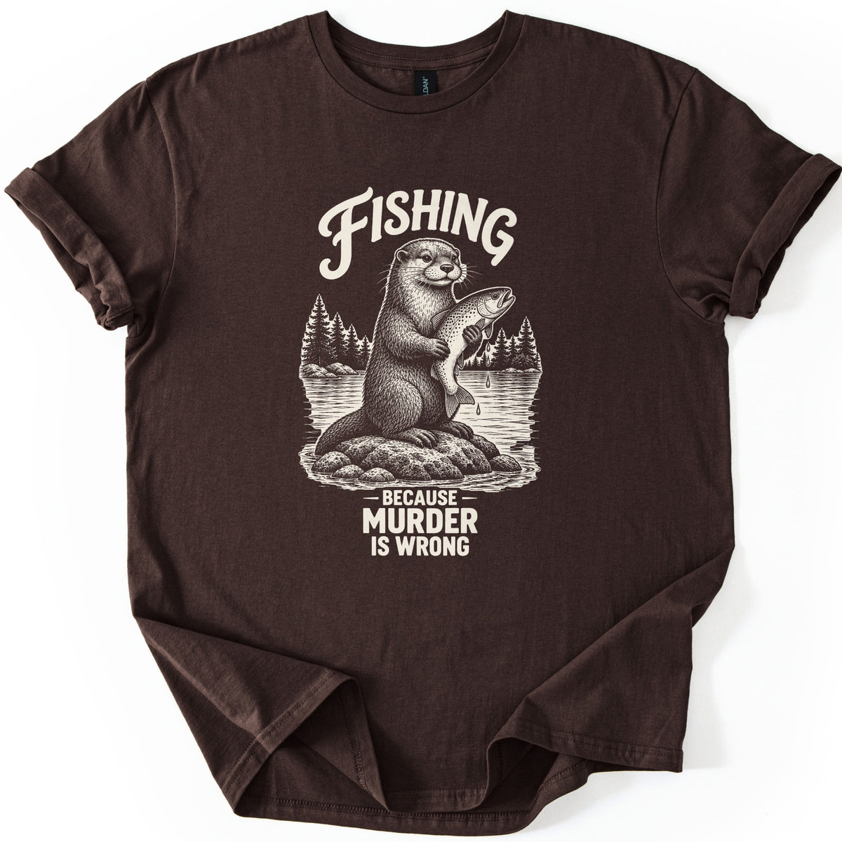 Fishing Murder Otter Comfort Colors T-shirt in Dark Chocolate, laid flat. A sketched otter sits on a rock in a lake holding a dripping trout, with pine trees behind it, under the word Fishing and above Because Murder Is Wrong in cream ink. Cuffed sleeves, white background.