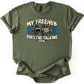 Freehub Does the Talking Comfort Colors T-shirt in Military Green, laid flat. A black and cream rear bicycle hub with blue sound-wave lines sits between the words My Freehub Does the Talking, with MTB below. The sleeves are rolled and it lies on a white background.