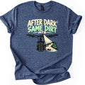 After Dark Same Dirt Comfort Colors T-shirt in Heather Navy, laid flat. A rider's-eye view of mountain bike handlebars, a headlight shining on a rocky dirt trail with a fern, under the words After Dark Same Dirt MTB and a crescent moon. Sleeves rolled, on a white background.