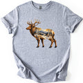 Aspen Pass Elk Comfort Colors T-shirt in Sport Grey, laid flat. A realistic bull elk stands facing left, its body filled with a snowy mountain trail lined with white aspens in golden leaves and dark pines. No words. The shirt lies on white with sleeves cuffed.
