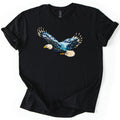 Eagle Glacier Valley Comfort Colors T-shirt in Black, laid flat. A bald eagle in flight, its body and wings filled with a scene of snowy mountains, a glacier, evergreen forest and blue water. No words are printed. The shirt has rolled sleeves on a white background.