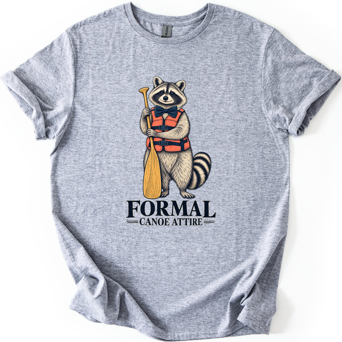 Formal Canoe Attire Comfort Colors T-shirt in Sport Grey, laid flat. A raccoon in a navy bow tie and orange life vest stands holding a wooden canoe paddle above the words FORMAL Canoe Attire. The shirt has rolled sleeves on a white background.