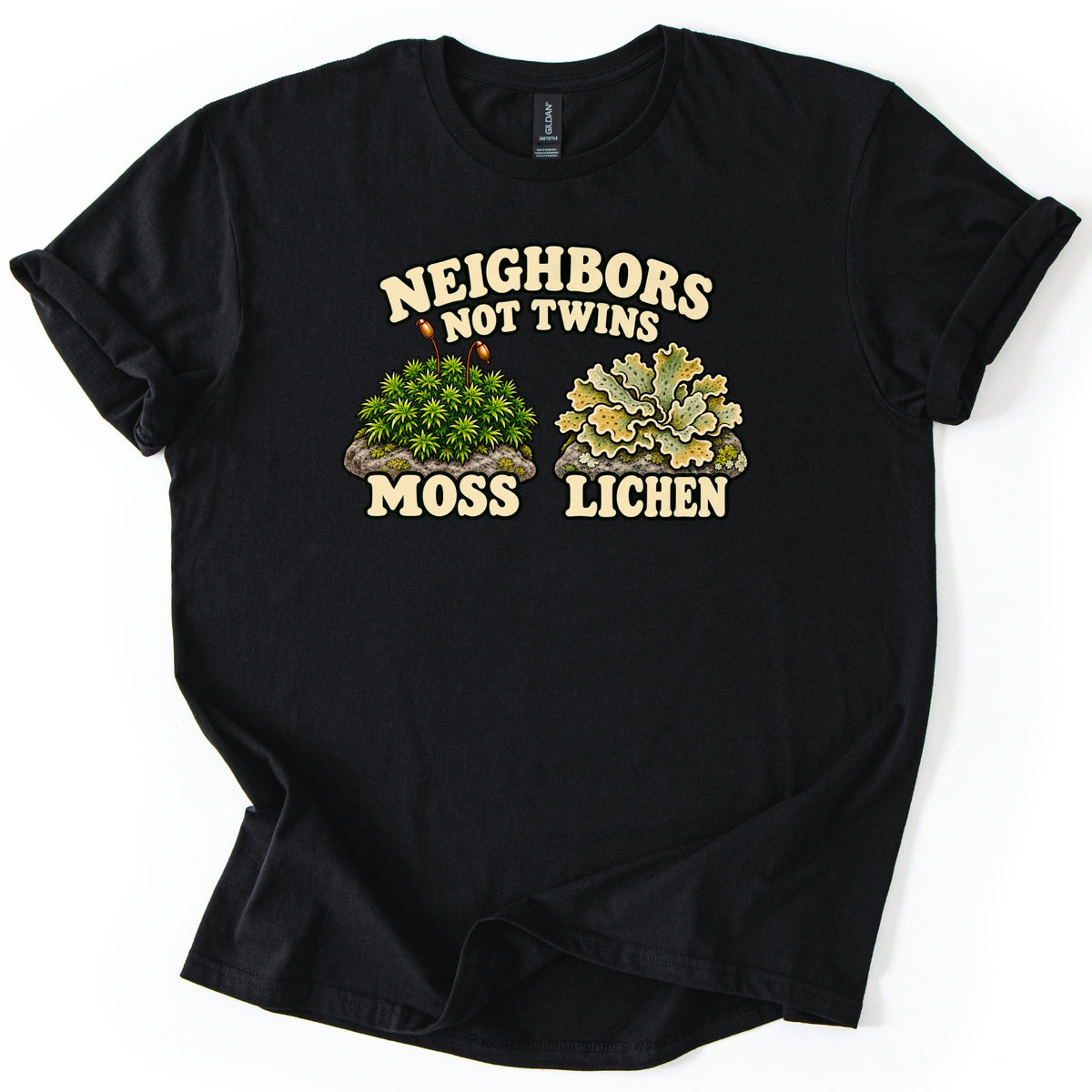 Neighbors Not Twins Comfort Colors T-shirt in Black, laid flat. Cream retro letters read Neighbors Not Twins above two rocks, one topped with green moss and two spore stalks labeled Moss, the other with pale green leafy lichen labeled Lichen. Sleeves rolled, on white.