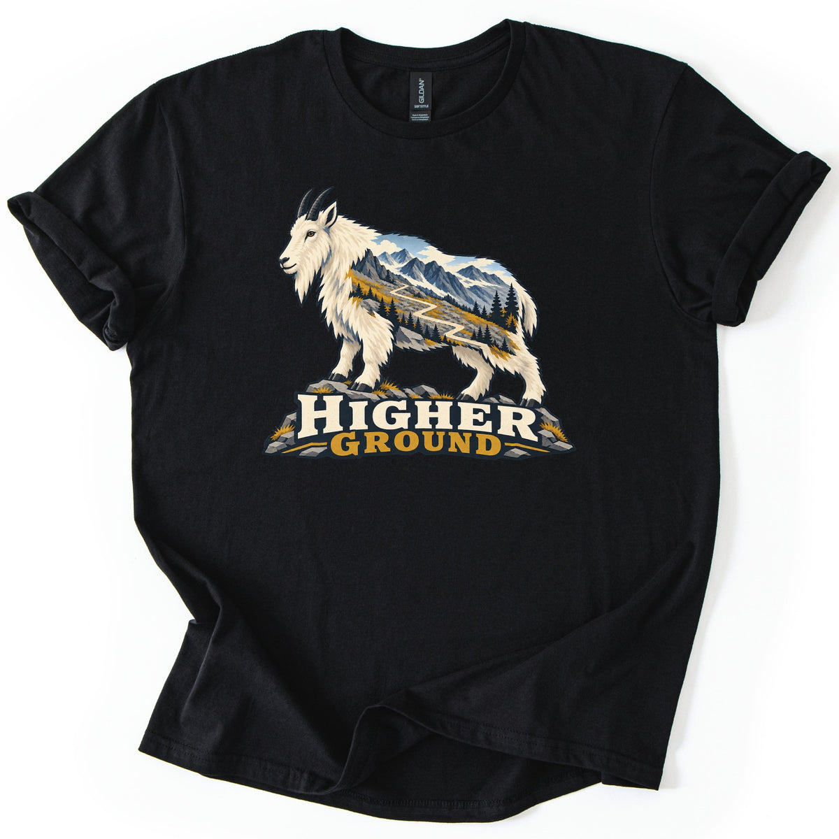 Higher Ground Comfort Colors T-shirt in Black, laid flat. A white mountain goat stands on gray rocks, its body filled with snowy peaks, pine trees and a winding trail, above the words Higher Ground in cream and gold. The sleeves are cuffed on a white background.