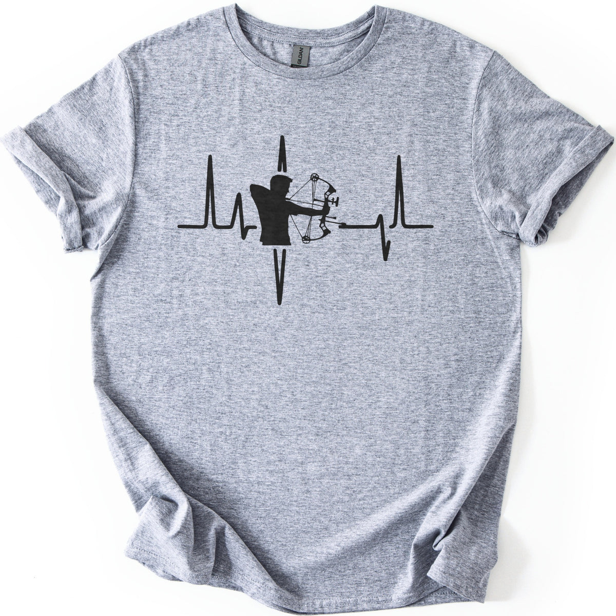 Compound Bow Archer Comfort Colors T-shirt in Sport Grey, laid flat. A black silhouette of an archer drawing a compound bow sits in the middle of a heartbeat line across the chest, with no words. The shirt lies on a white background with its sleeves cuffed.