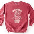 Woodworking Because Murder Is Wrong Comfort Colors crewneck sweatshirt in Crimson, laid flat. A cream sketch-style beaver sits on a pile of logs gnawing a log, with Woodworking arched above and Because Murder Is Wrong below. It lies on a white surface with the sleeves spread out.