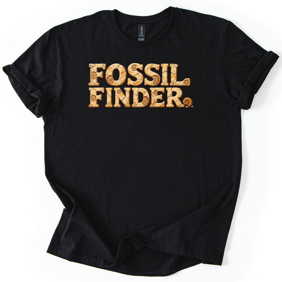 Fossil Finder Comfort Colors T-shirt in Black, laid flat. The words Fossil Finder in chunky cracked tan stone letters with ammonite fossil imprints, and a small ammonite shell as the period. The shirt has cuffed sleeves on a white background.