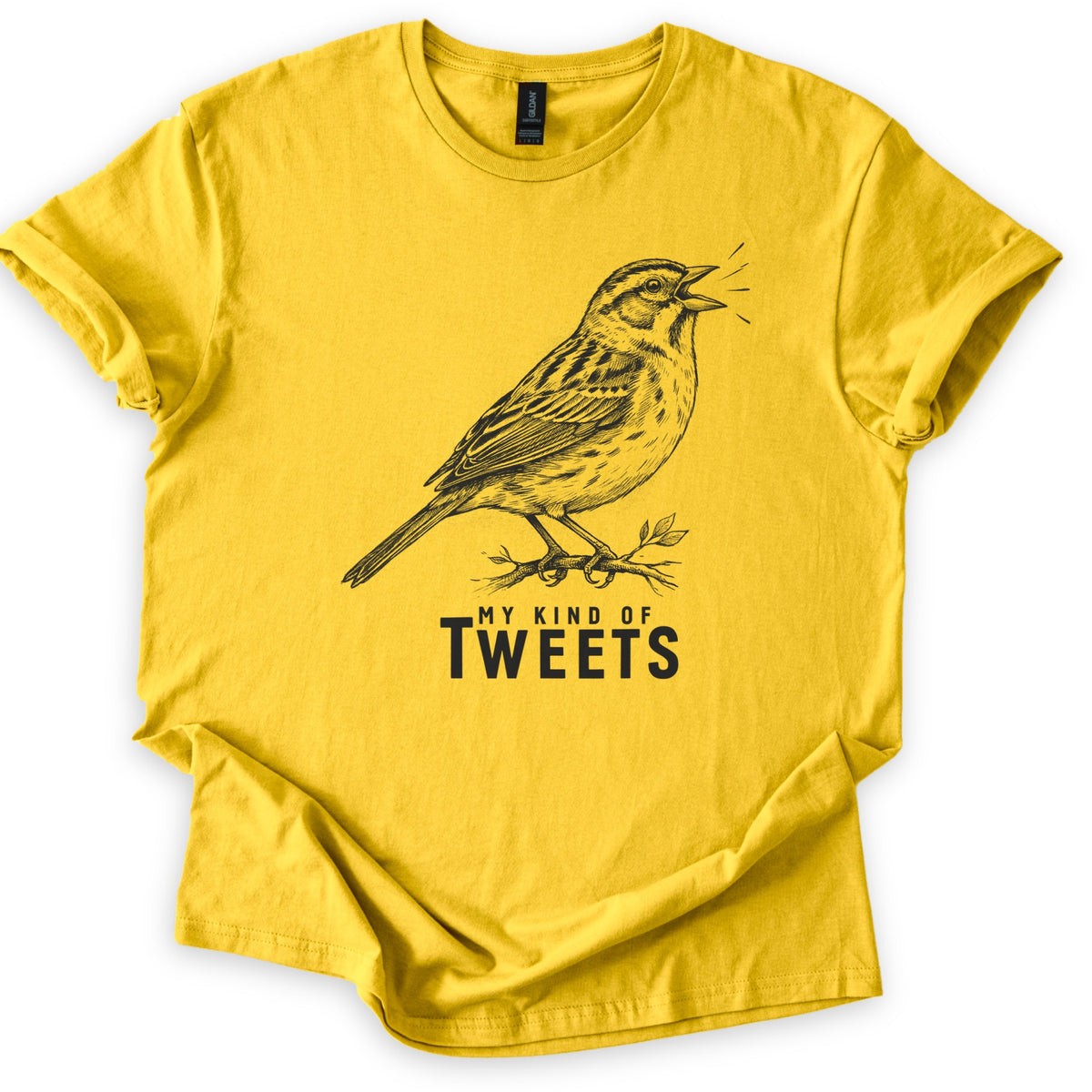 My Kind Of Tweets Comfort Colors T-shirt in Daisy, laid flat. A black sketch-style drawing of a sparrow singing on a leafy twig, with short lines by its open beak, above the words My Kind Of Tweets. The sleeves are cuffed and the shirt lies on a white background.
