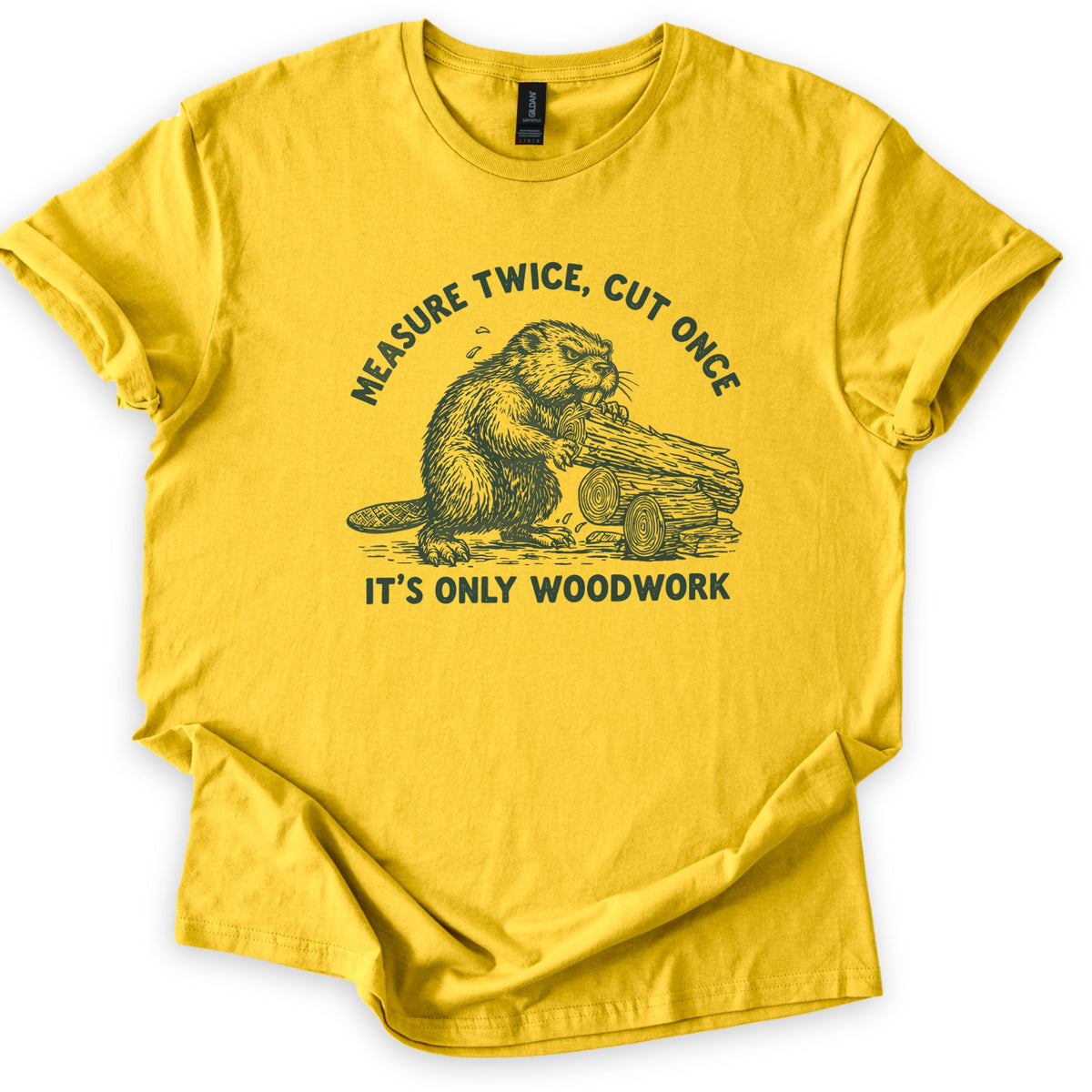 Measure Twice Beaver Comfort Colors T-shirt in Daisy, laid flat. A dark green sketch of a beaver gnawing a log beside cut logs, under the arched words Measure Twice, Cut Once and above It's Only Woodwork. The shirt has rolled sleeves on a white background.