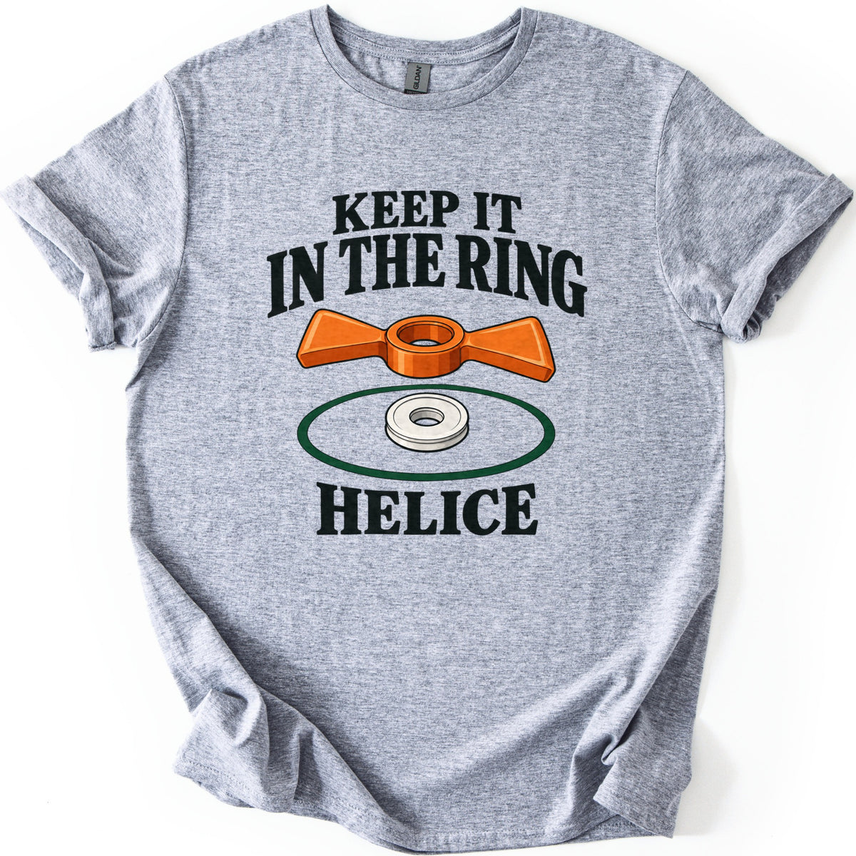 Keep It in the Ring Comfort Colors T-shirt in Sport Grey, laid flat. An orange two-winged helice target sits above a white disc inside a green ring, between the words Keep It in the Ring and Helice. The shirt lies smooth on a white background with cuffed sleeves.