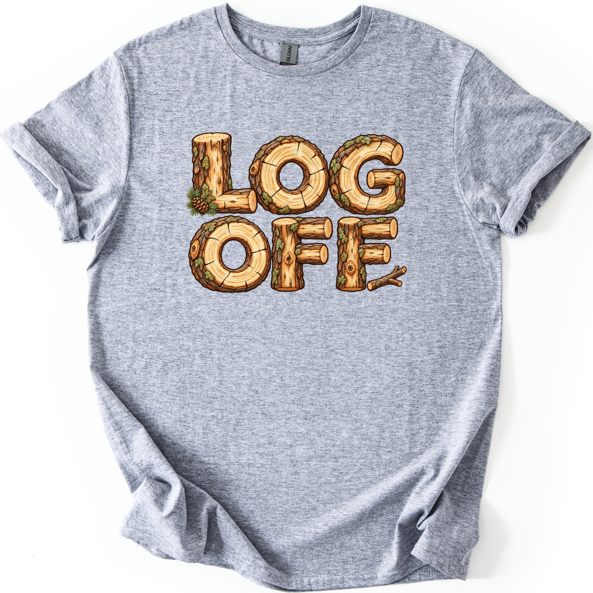 Log Off Comfort Colors T-shirt in Sport Grey, laid flat. The words LOG OFF are spelled in letters made of cut logs with bark, moss and tree rings, with a pine sprig and cone by the L and a twig after the last F. Sleeves are rolled on a white background.