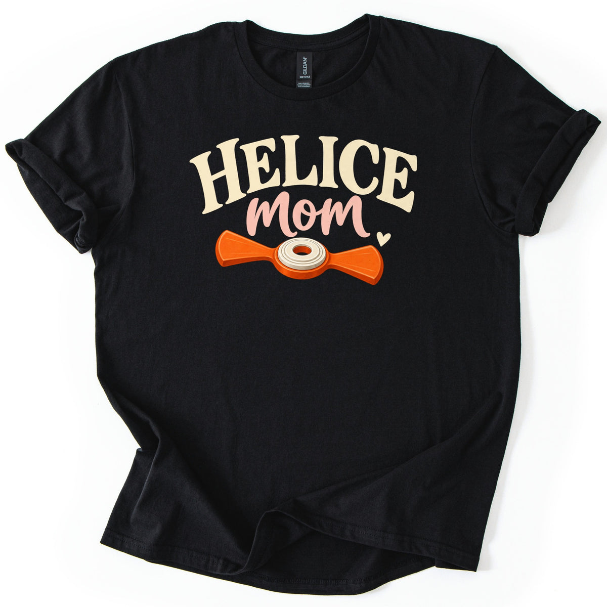 Helice Mom Comfort Colors T-shirt in Black, laid flat. Cream arched letters read HELICE above pink script reading mom with a small heart, over an orange two-bladed helice target with a cream center ring. The shirt has rolled sleeves on a white background.