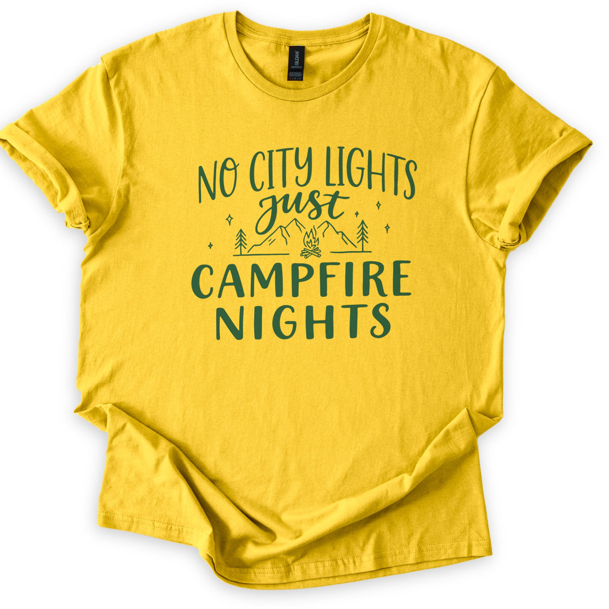 Campfire Nights Comfort Colors T-shirt in Daisy, laid flat. Dark green print reads No City Lights just Campfire Nights, with a line drawing of mountains, pine trees, stars and a small campfire. The sleeves are rolled and the shirt lies on a white background.