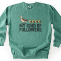 My Kind Of Followers Comfort Colors crewneck sweatshirt in Light Green, laid flat. A mallard duck walks ahead of four ducklings in a row above the words MY KIND OF FOLLOWERS in distressed black capital letters. The sweatshirt lies on a white background.