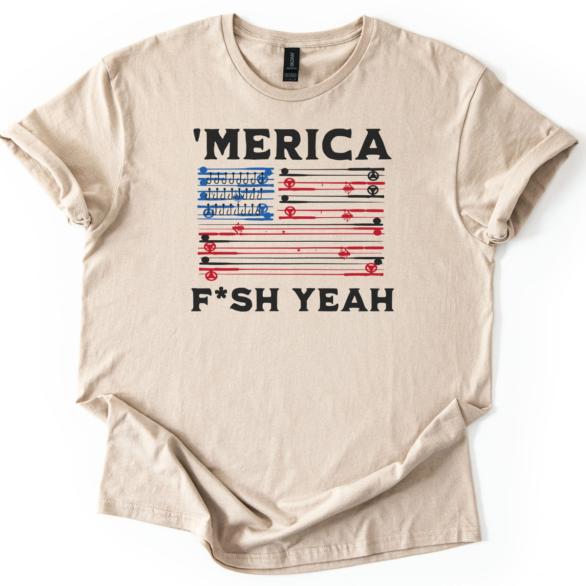 Fish America Fish Yeah Comfort Colors T-shirt in Sand, laid flat. An American flag of red and black fishing rods and reels, with hooks lined up in the blue corner, is framed by 'MERICA above and F*SH YEAH below in black. Sleeves rolled, on a white background.