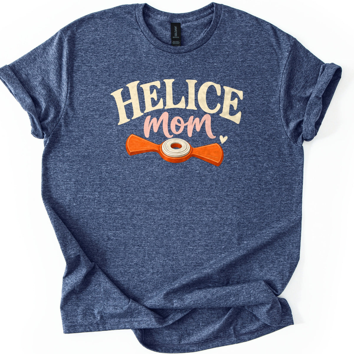 Helice Mom Comfort Colors T-shirt in Heather Navy, laid flat. Cream arched letters read HELICE above pink script reading mom with a small heart, over an orange two-bladed helice target with a cream center ring. The shirt has rolled sleeves on a white background.