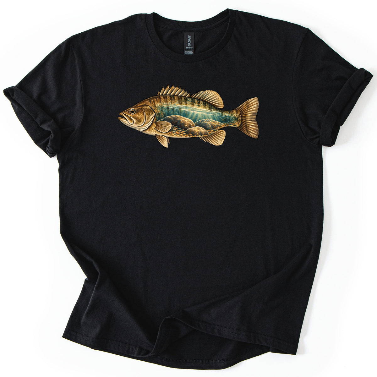 Rocky Shallows Bass Comfort Colors T-shirt in Black, laid flat. A gold and brown bass is printed across the chest, its body filled with an underwater scene of teal water, light rays and rounded rocks. No words are printed. The shirt has rolled sleeves on a white background.