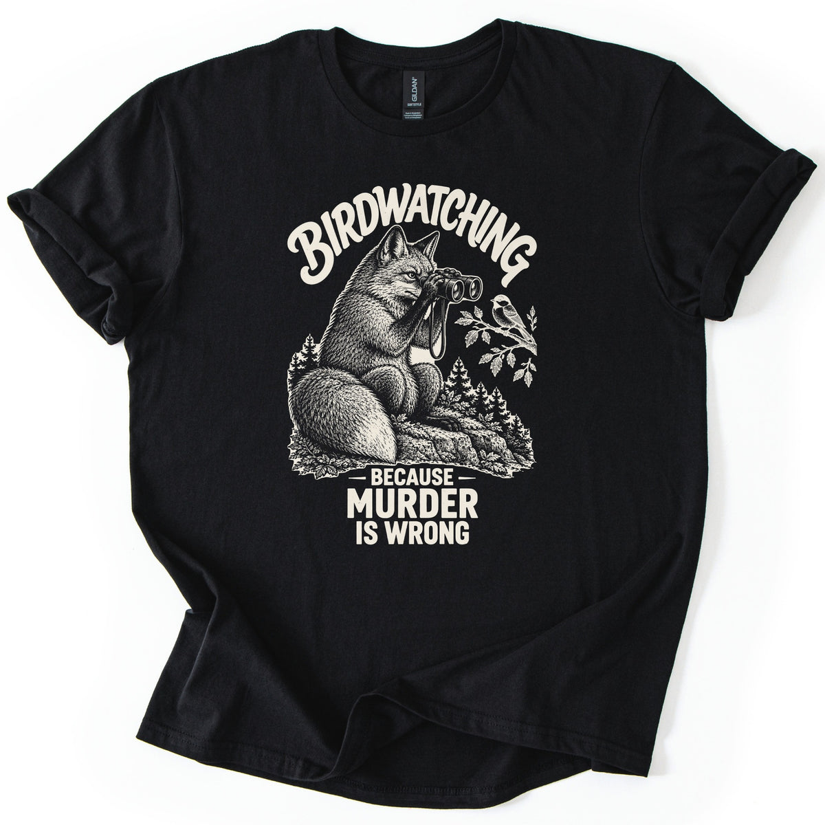 Birdwatching Murder Fox Comfort Colors T-shirt in Black, laid flat. A sketched fox sits on a rock peering through binoculars at a chickadee on a branch, with Birdwatching arched above and Because Murder Is Wrong below, in cream ink. On a white surface, sleeves cuffed.