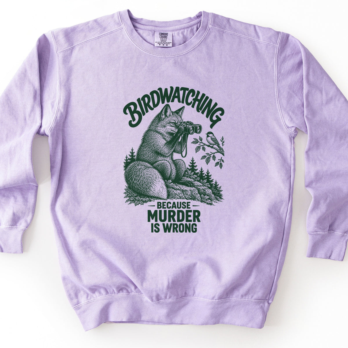 Birdwatching Because Murder Is Wrong Comfort Colors crewneck sweatshirt in Orchid, laid flat. A dark green sketch of a fox on a rock using binoculars to watch a small bird on a leafy branch, with pine trees behind. Birdwatching arches above; Because Murder Is Wrong is below. White background.