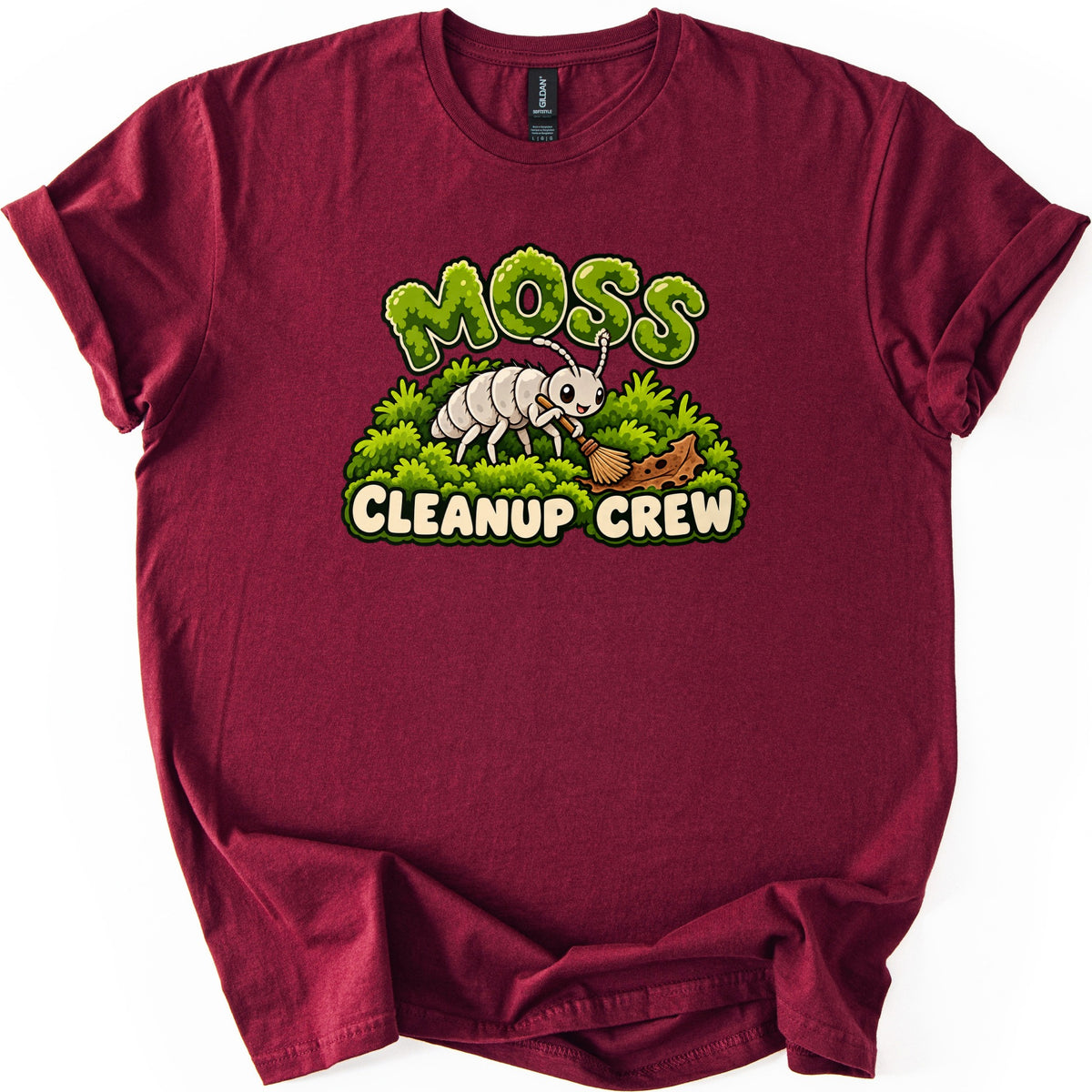 Moss Cleanup Crew Comfort Colors T-shirt in Maroon, laid flat. The word MOSS in green mossy letters tops a smiling white cartoon bug sweeping brown debris off a mound of moss with a broom, above the words CLEANUP CREW. Cuffed sleeves, on a white background.