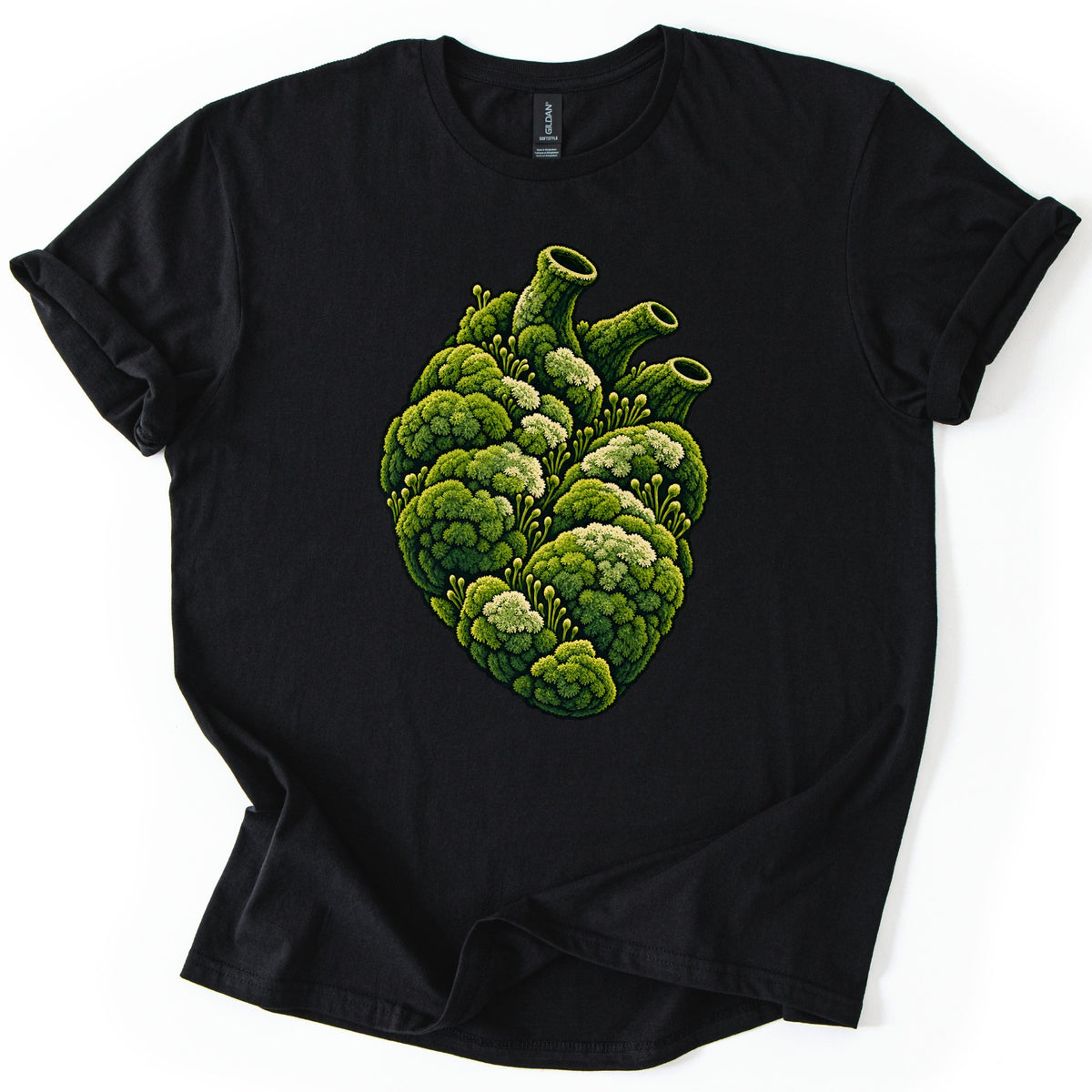 Moss Heart Comfort Colors T-shirt in Black, laid flat. An anatomical heart made of clumps of green moss, with pale tufts, small sprouting stalks and three tube-like vessels on top, with no words. The shirt lies on a white surface with sleeves cuffed.