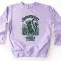 Aromatherapy Because Murder Is Wrong Comfort Colors crewneck sweatshirt in Orchid, laid flat. Dark green line art of a skunk sniffing a bundle of lavender among wildflowers, a basket and an essential oil bottle, with Aromatherapy above and Because Murder Is Wrong below. Shown on a white surface.