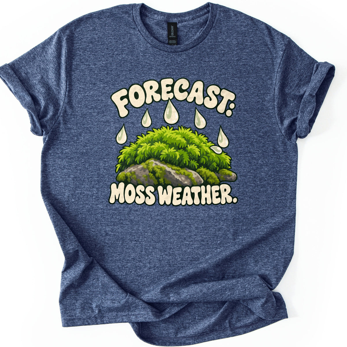 Forecast Moss Weather Comfort Colors T-shirt in Heather Navy, laid flat. Cream bubble letters read FORECAST: above white raindrops falling on a mound of bright green moss over gray rocks, with MOSS WEATHER. below. The shirt has rolled sleeves on a white background.