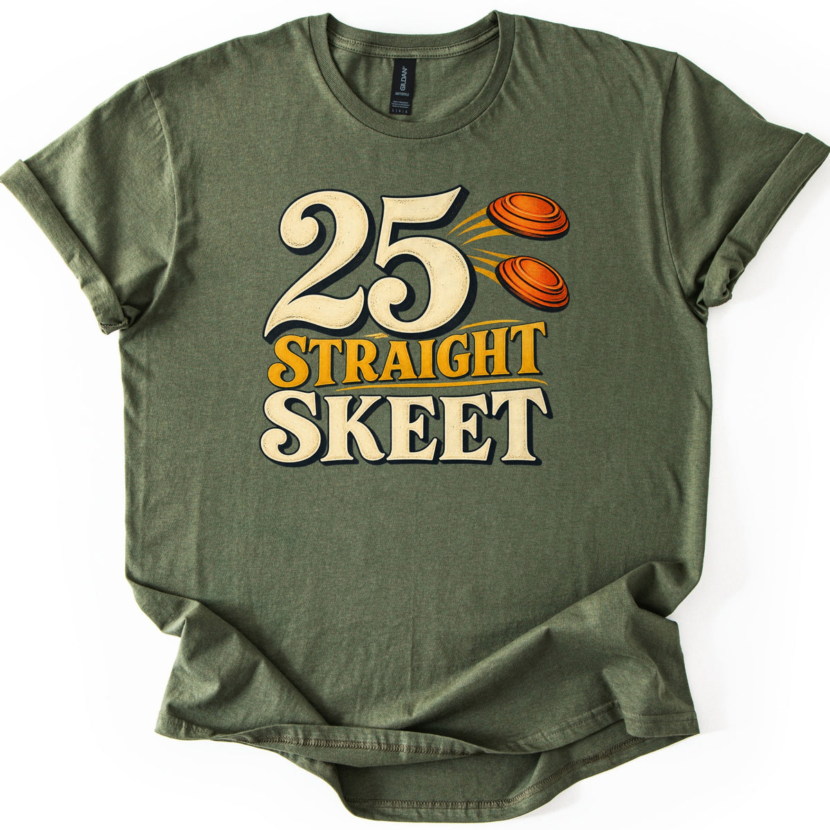 25 Straight Skeet Comfort Colors T-shirt in Military Green, laid flat. Large cream numbers 25 with two orange clay targets flying beside them, above the words Straight Skeet in gold and cream lettering. The shirt has rolled sleeves on a white background.